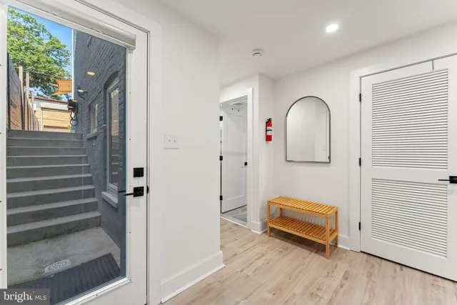 a view of a hallway with entryway wooden floor and front door