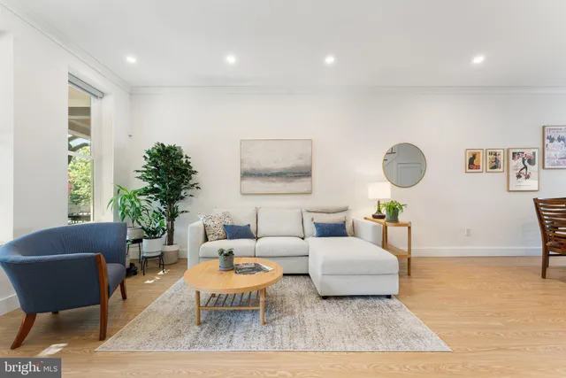 a living room with furniture and wooden floor