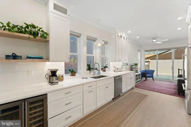 a spacious bathroom with a double vanity sink a mirror and a bathtub