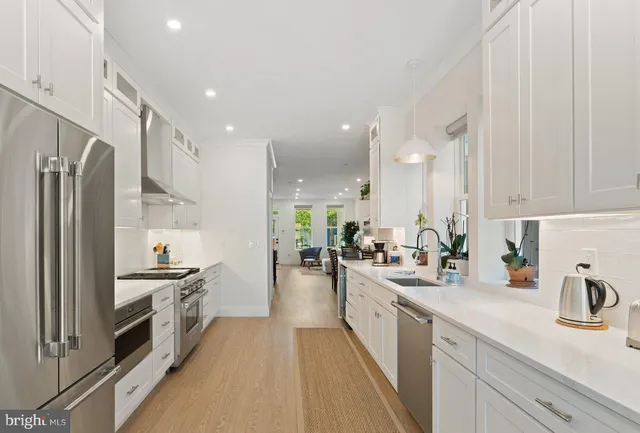 a kitchen with stainless steel appliances a sink stove and refrigerator