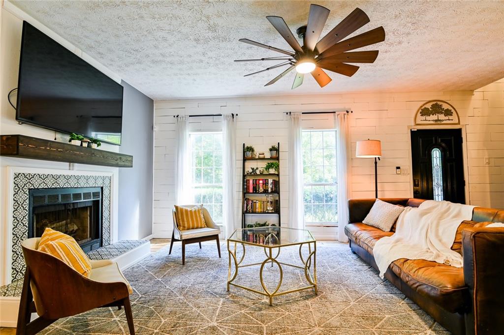 40 Mildred Lane Covington, GA 30016 - Photo 11 of 56 a living room with furniture a flat screen tv and a fireplace