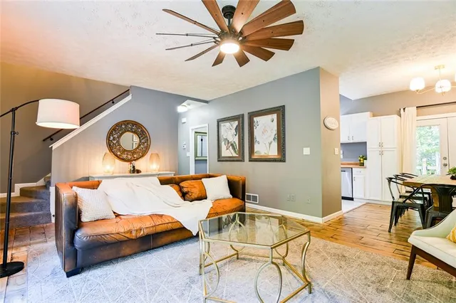 a living room with furniture a fireplace and a table