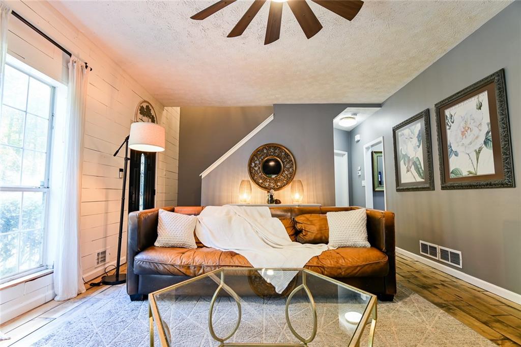 40 Mildred Lane Covington, GA 30016 - Photo 14 of 56 a living room with furniture and a floor to ceiling window