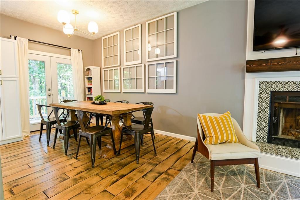 40 Mildred Lane Covington, GA 30016 - Photo 15 of 56 a dining room with furniture a fireplace and wooden floor