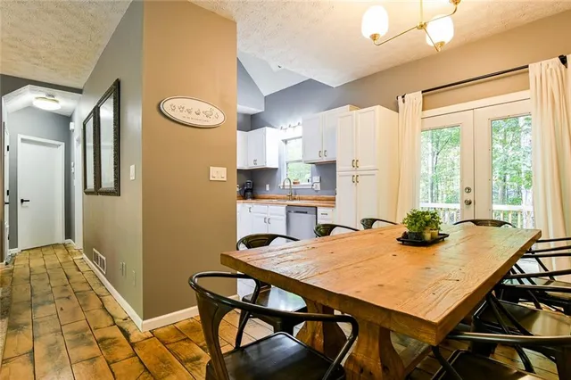 a kitchen with cabinets appliances a sink and a window