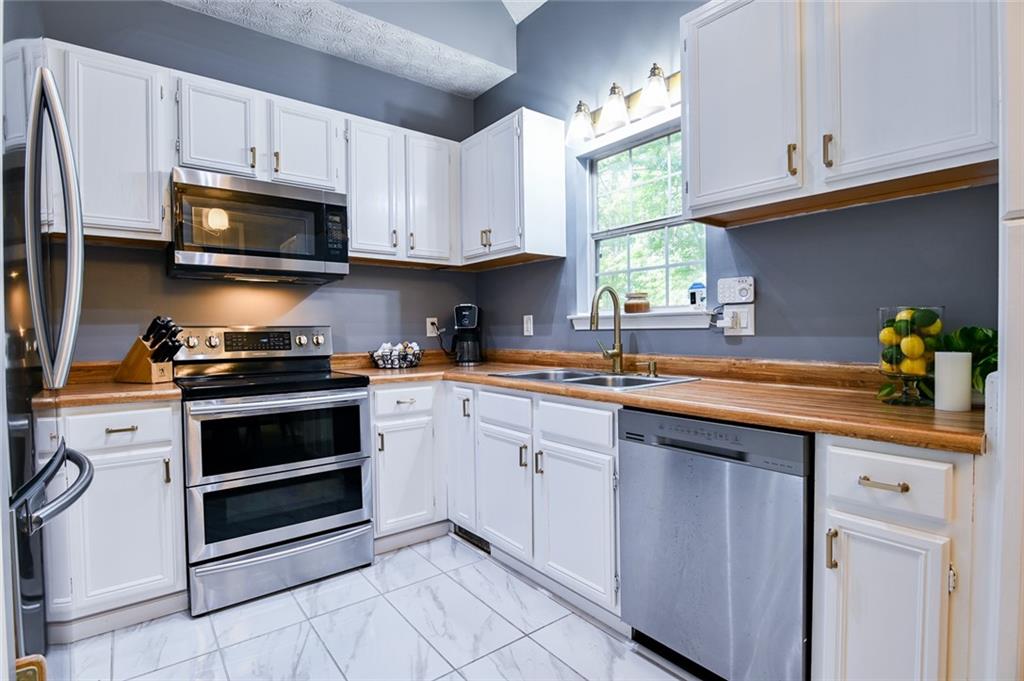 40 Mildred Lane Covington, GA 30016 - Photo 17 of 56 a kitchen with cabinets appliances a sink and a window