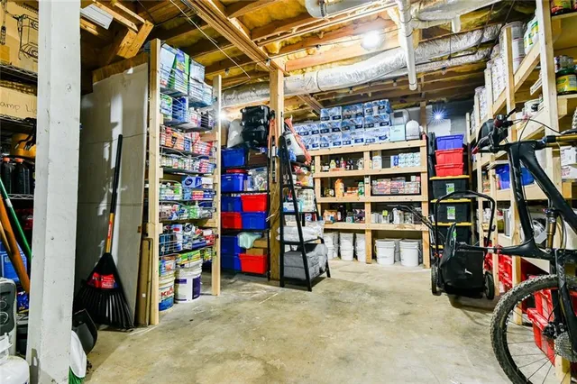 a bedroom with a bed and teddy bear on bed