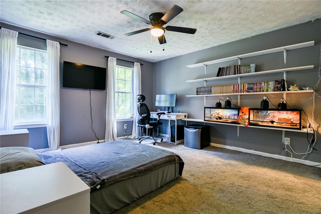 40 Mildred Lane Covington, GA 30016 - Photo 35 of 56 a living room with furniture and a flat screen tv