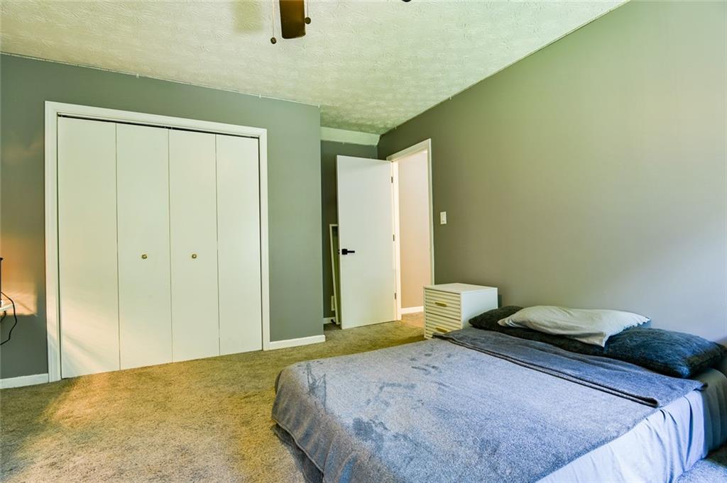 40 Mildred Lane Covington, GA 30016 - Photo 36 of 56 a bedroom with a bed and teddy bear on bed