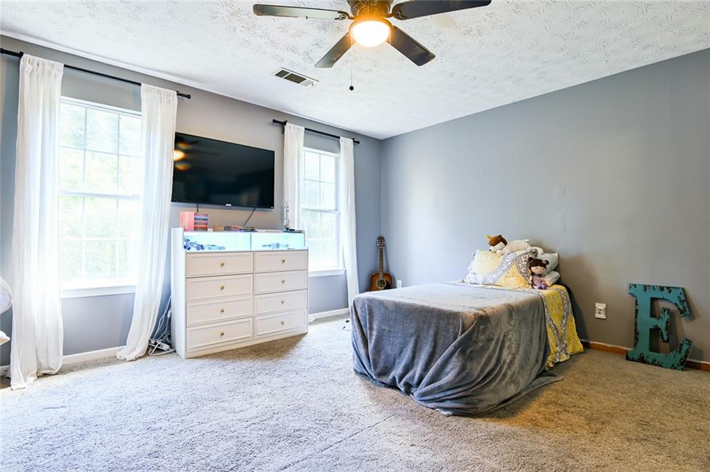 40 Mildred Lane Covington, GA 30016 - Photo 40 of 56 a bedroom with a bed and a flat screen tv