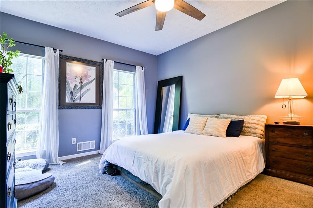 40 Mildred Lane Covington, GA 30016 - Photo 43 of 56 a bedroom with a large bed and a chandelier