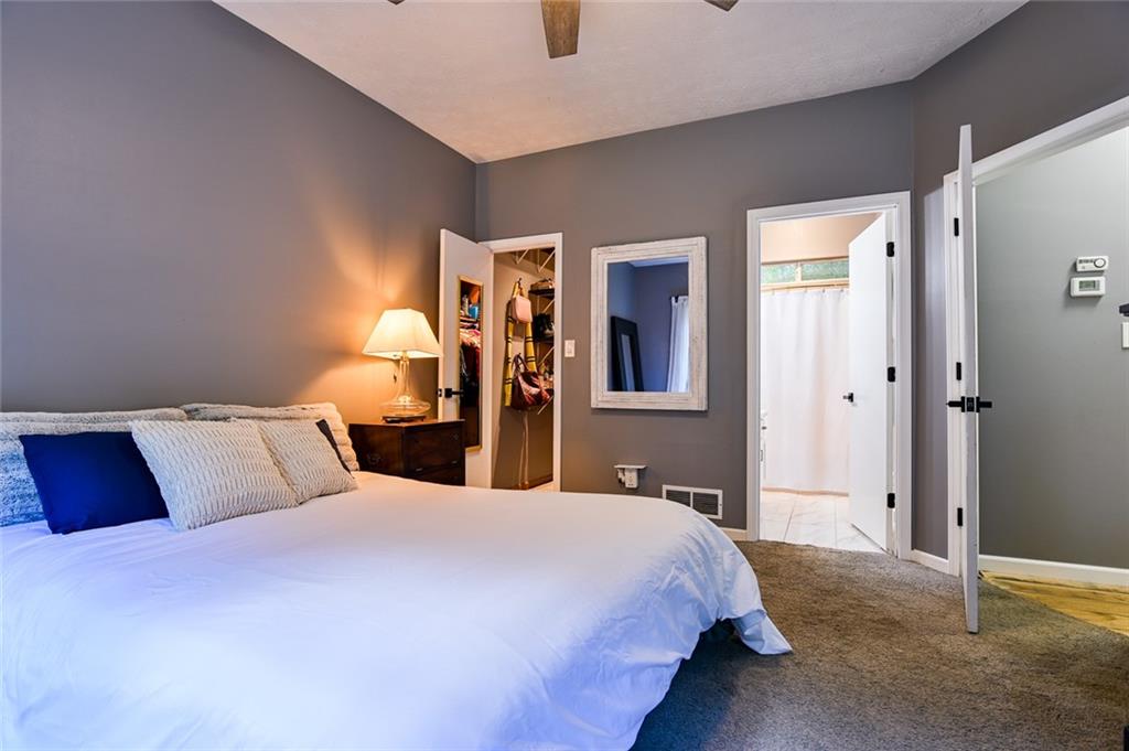 40 Mildred Lane Covington, GA 30016 - Photo 44 of 56 a bedroom with a large bed and wooden floor