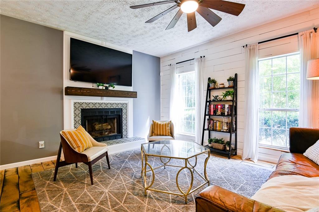 40 Mildred Lane Covington, GA 30016 - Photo 9 of 56 a living room with furniture a flat screen tv and a fireplace
