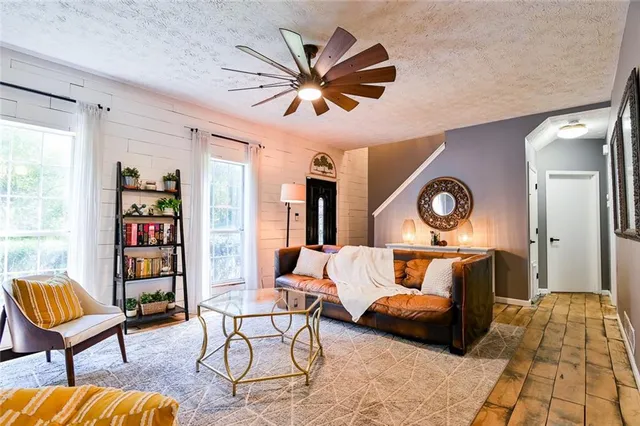 a living room with furniture a flat screen tv and a fireplace