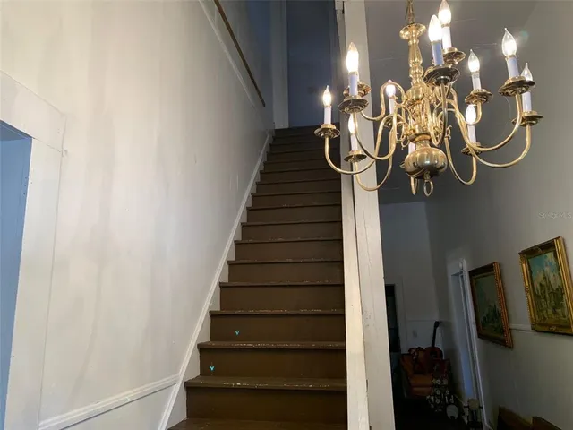 a living room with a chair and a window