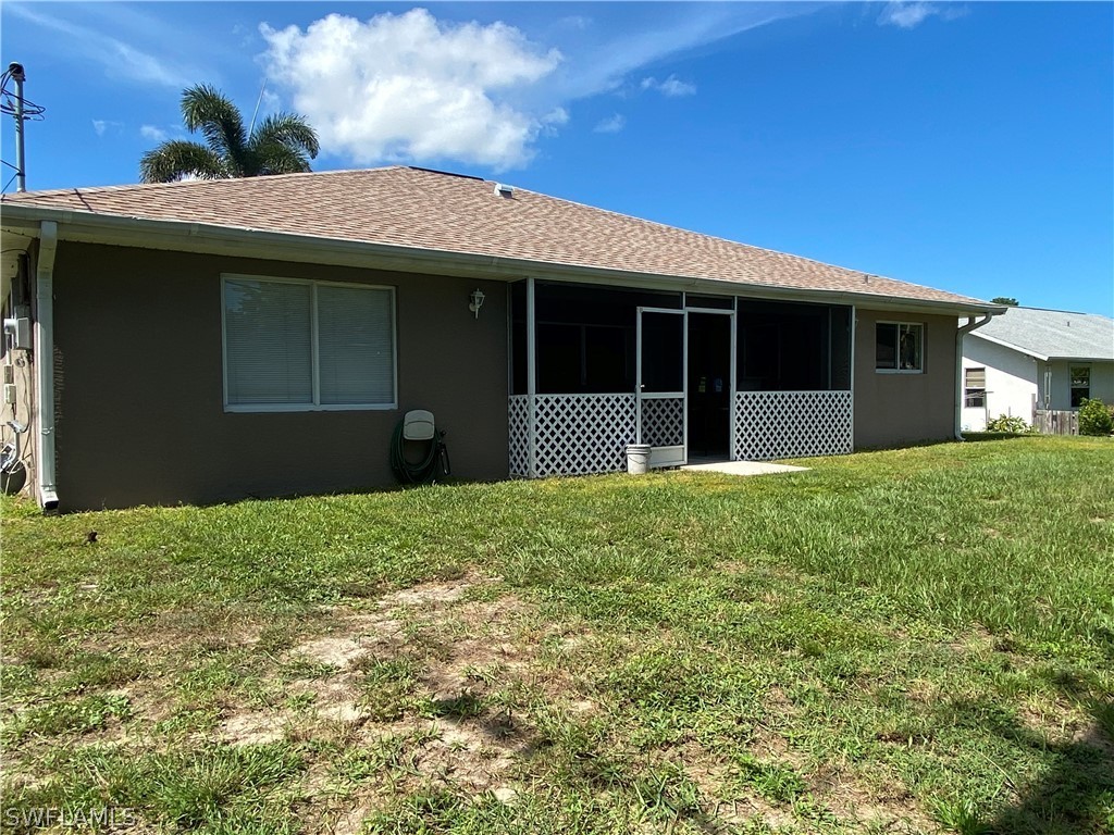 8293 Bahamas Road Fort Myers, FL 33967 - Photo 2 of 22 a front view of a house with a garden