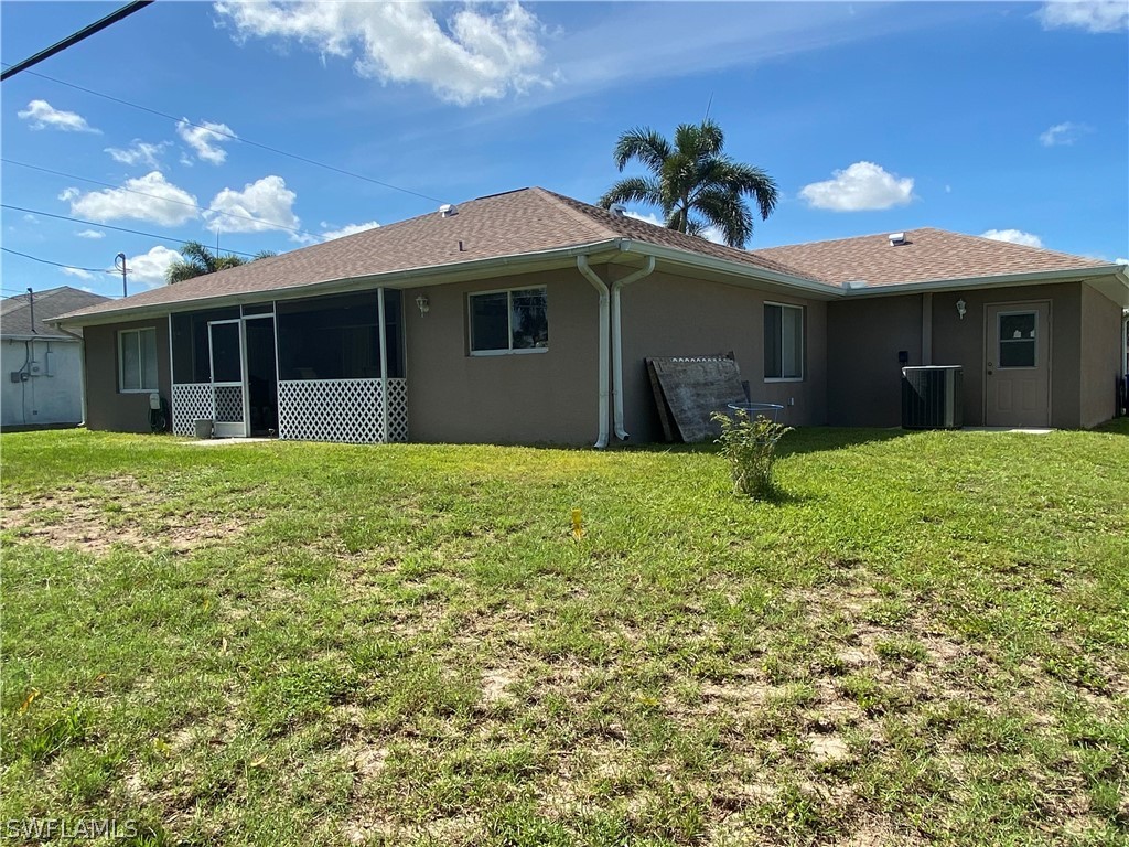 8293 Bahamas Road Fort Myers, FL 33967 - Photo 3 of 22 a view of a house with a yard