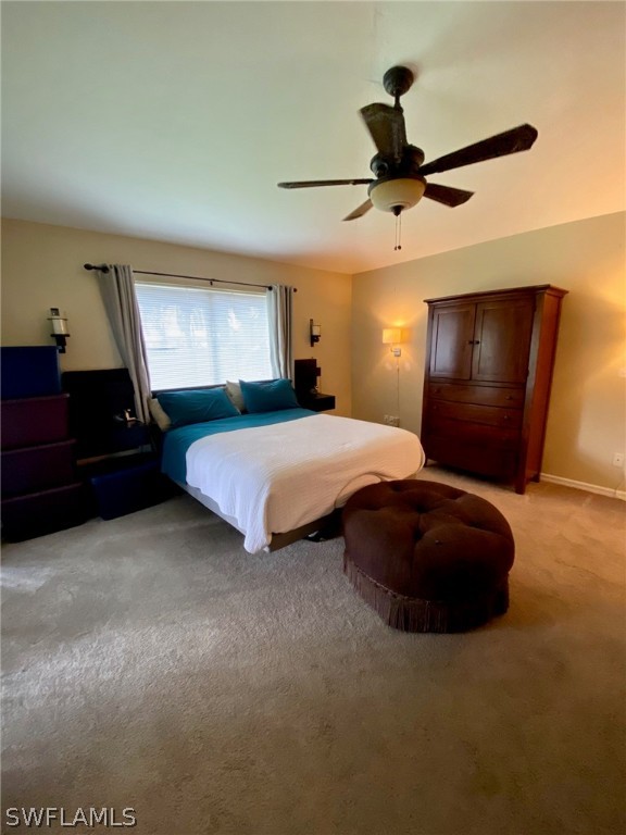 8293 Bahamas Road Fort Myers, FL 33967 - Photo 9 of 22 a bedroom with a bed and a chandelier