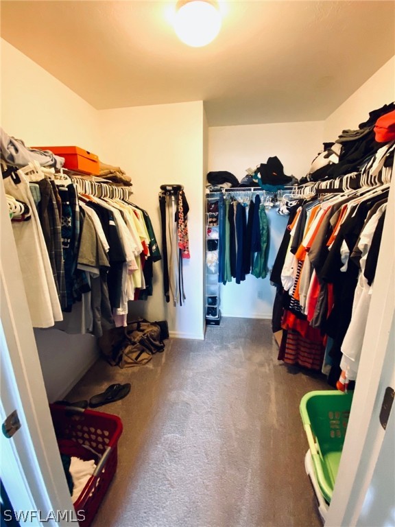 8293 Bahamas Road Fort Myers, FL 33967 - Photo 10 of 22 a view of walk in closet with clothes and shoes
