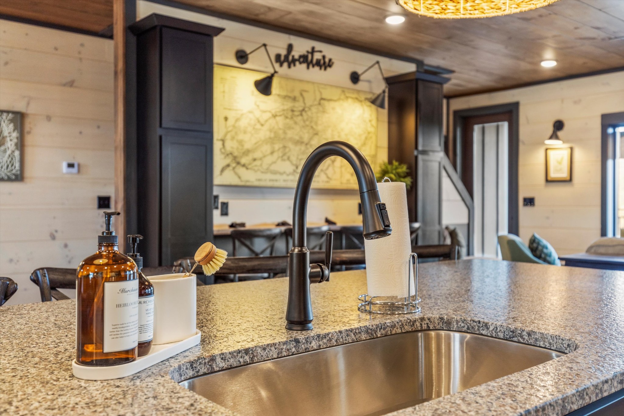 328 Rambling Creek Way Sevierville, TN 37862 - Photo 32 of 66 a kitchen with a faucet a dining table and chairs