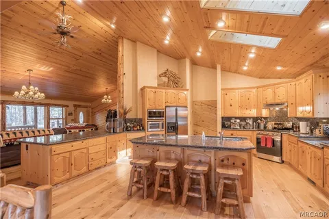 a large kitchen with a table and chairs