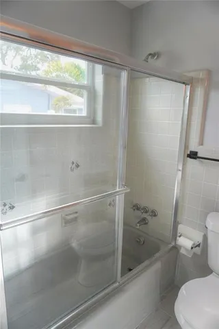a bathroom with a shower and a toilet