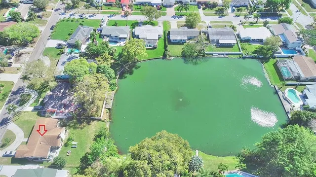 an aerial view of residential houses with outdoor space and street view