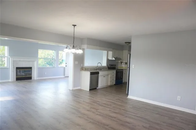a kitchen with kitchen island a sink and a stove