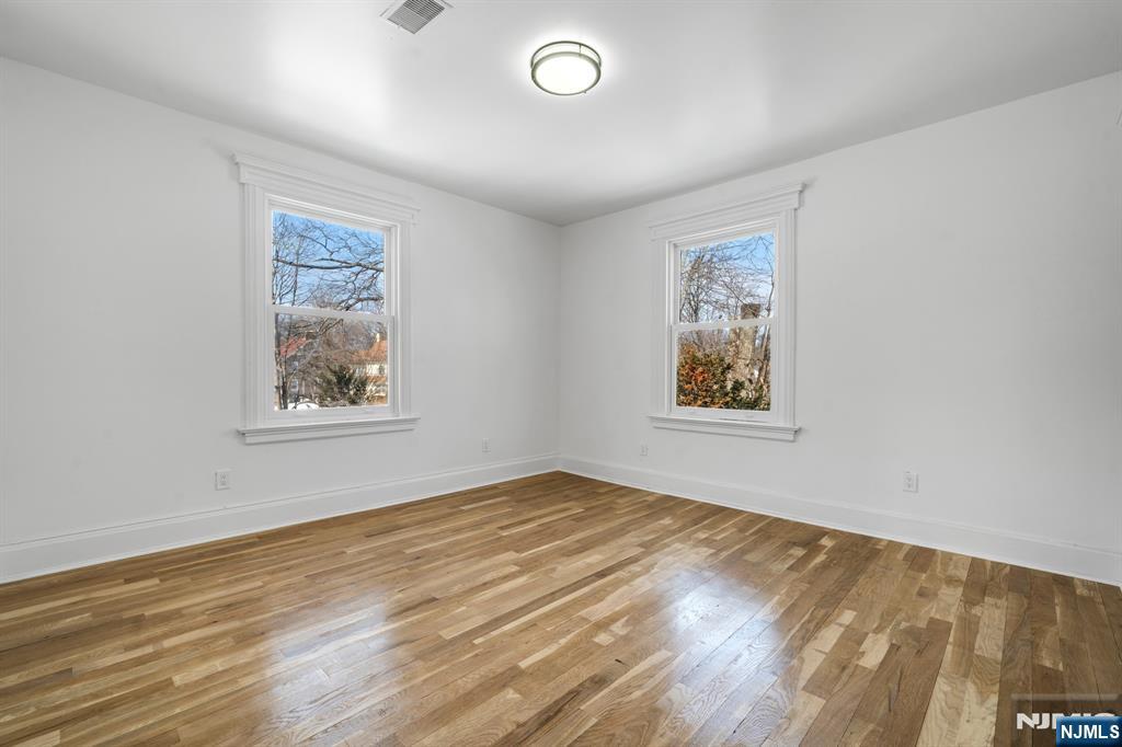 60 Stanley Road South Orange, NJ 07079 - Photo 16 of 40 a view of an empty room with window and wooden floor