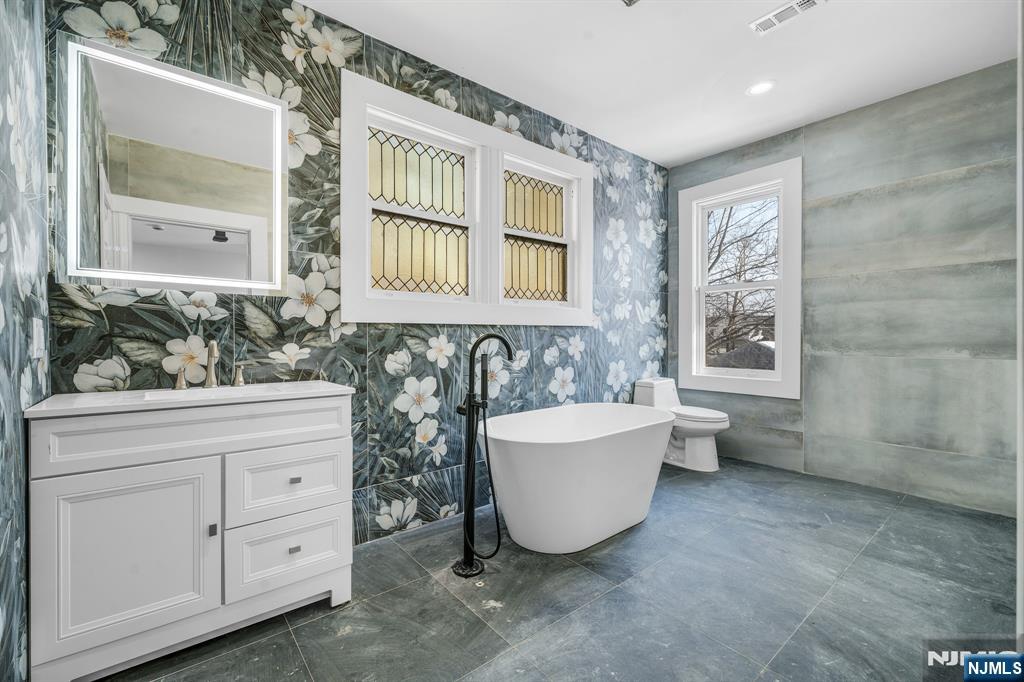 60 Stanley Road South Orange, NJ 07079 - Photo 17 of 40 a spacious bathroom with a bathtub sink and mirror