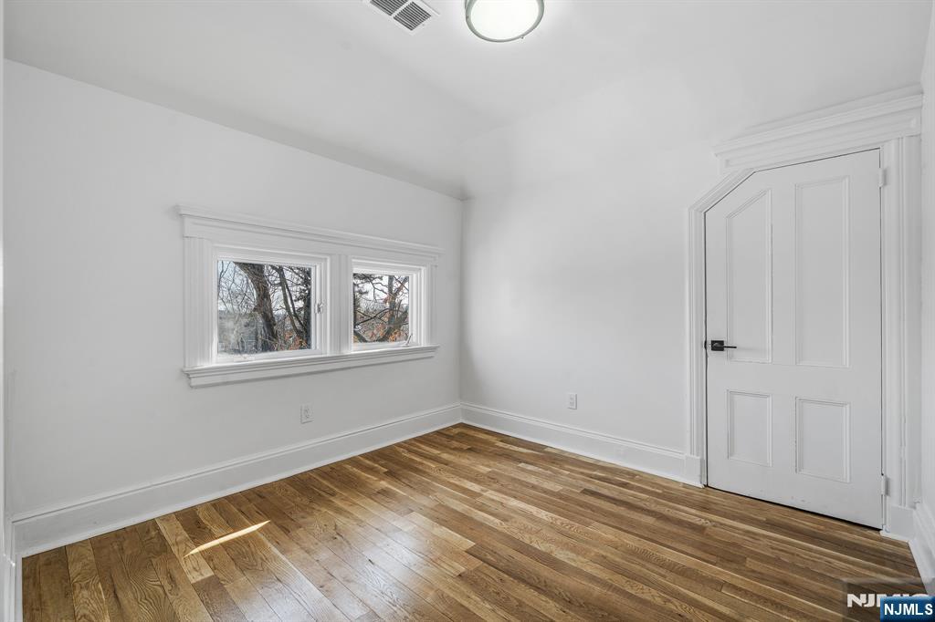 60 Stanley Road South Orange, NJ 07079 - Photo 18 of 40 a view of an empty room with wooden floor and a window