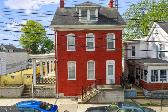 a front view of a house with glass windows and door