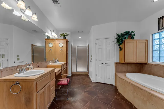 a spacious bathroom with a double vanity sink mirror and