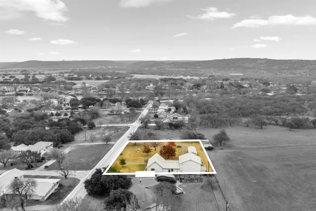 an aerial view of houses with yard