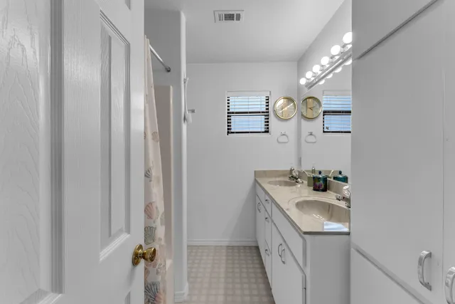 a bathroom with a sink a vanity and a mirror