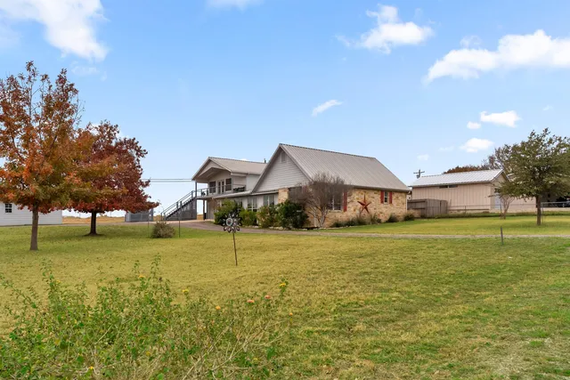a front view of house with yard and trees