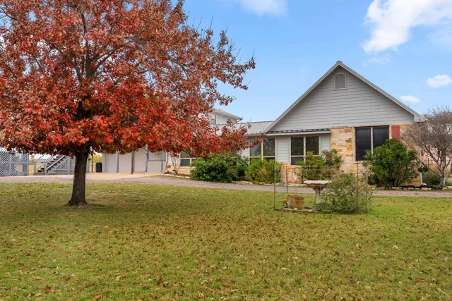 a front view of house with yard and trees