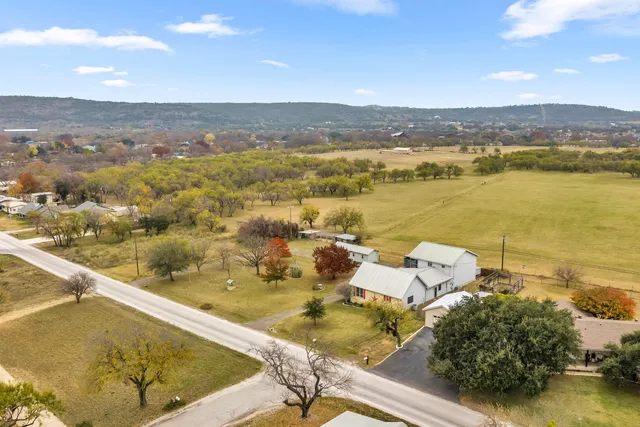 an aerial view of residential houses with outdoor space