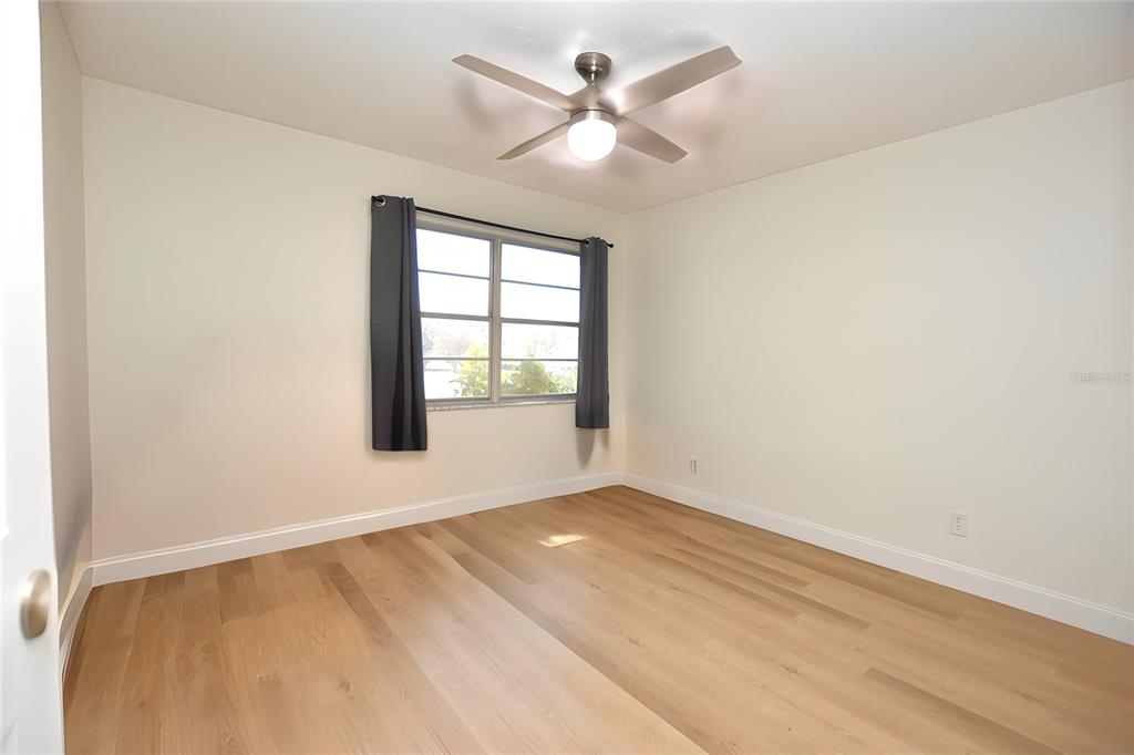 2025 Sylvester Road, Unit S2 Lakeland, FL 33803 - Photo 11 of 36 an empty room with windows and fan
