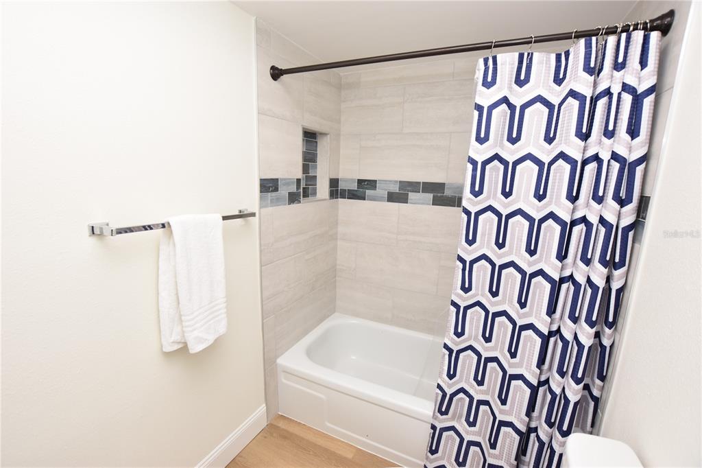 2025 Sylvester Road, Unit S2 Lakeland, FL 33803 - Photo 13 of 36 a bathroom with a bathtub and a shower