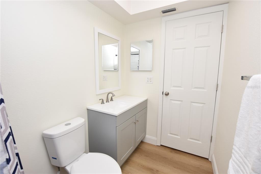 2025 Sylvester Road, Unit S2 Lakeland, FL 33803 - Photo 14 of 36 a bathroom with a toilet a sink a mirror and vanity