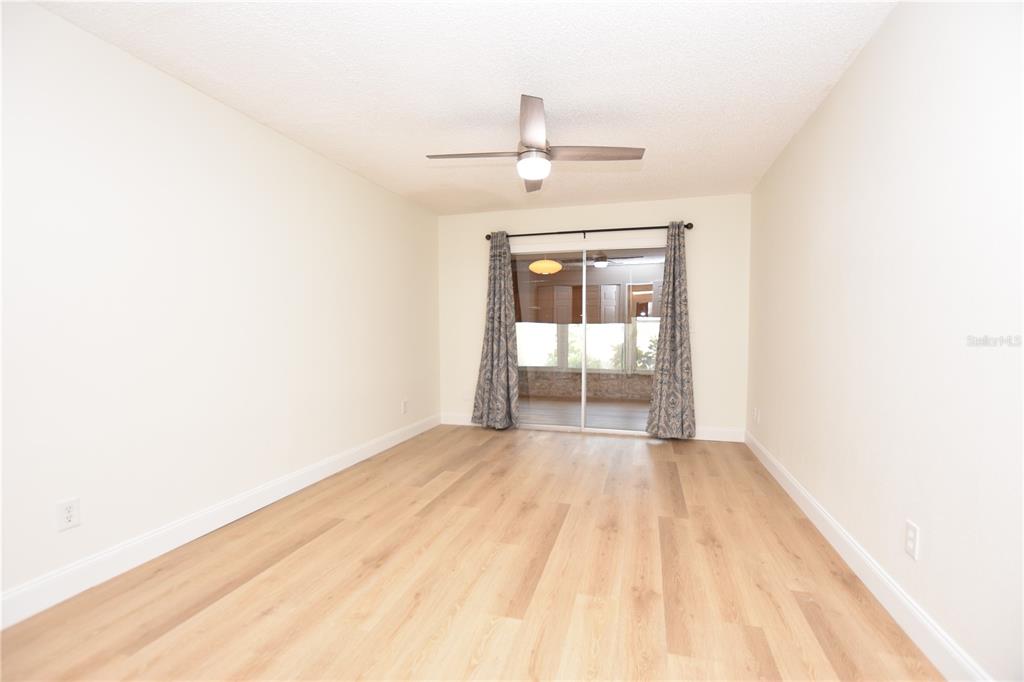 2025 Sylvester Road, Unit S2 Lakeland, FL 33803 - Photo 16 of 36 a view of a room with wooden floor a ceiling fan