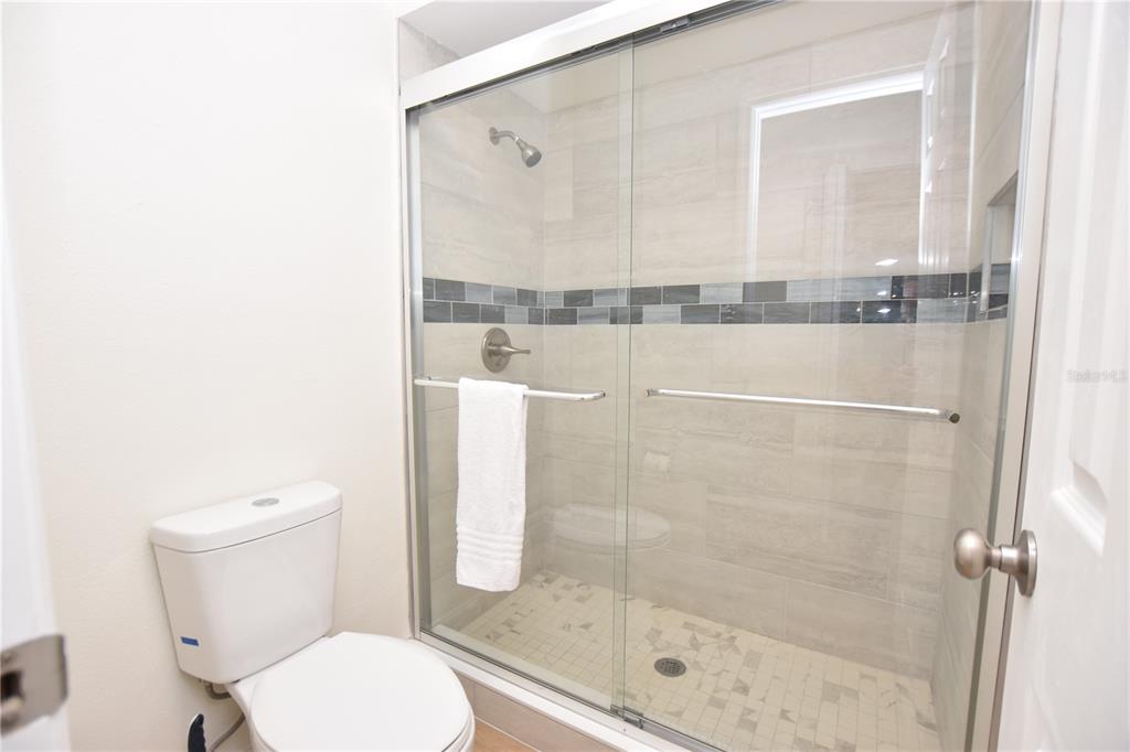 2025 Sylvester Road, Unit S2 Lakeland, FL 33803 - Photo 18 of 36 a bathroom with a toilet and a shower