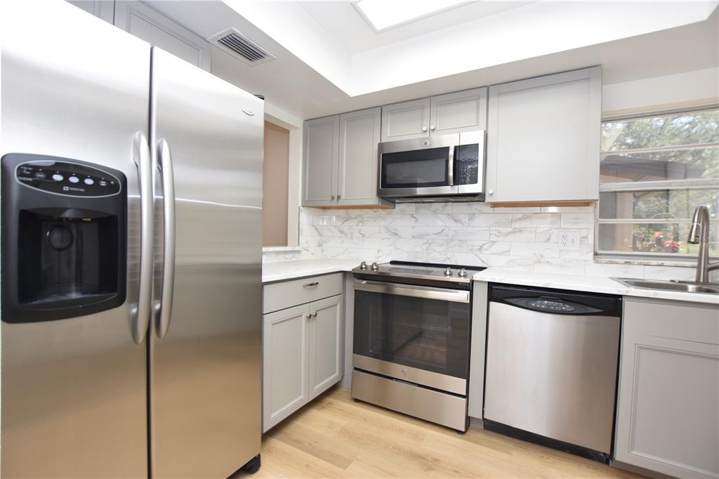 2025 Sylvester Road, Unit S2 Lakeland, FL 33803 - Photo 2 of 36 a kitchen with stainless steel appliances granite countertop a refrigerator and a sink