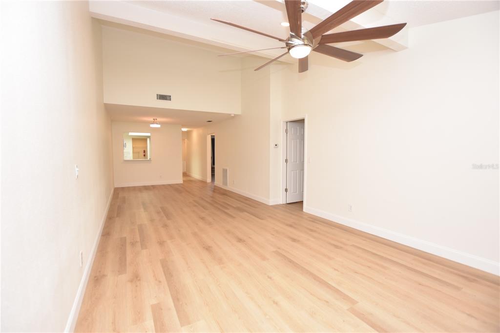 2025 Sylvester Road, Unit S2 Lakeland, FL 33803 - Photo 25 of 36 a view of a big room with wooden floor and a ceiling fan