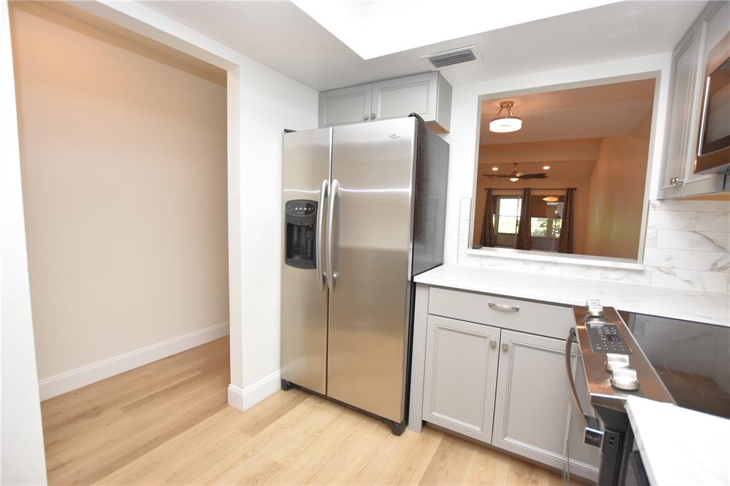 2025 Sylvester Road, Unit S2 Lakeland, FL 33803 - Photo 3 of 36 a metallic refrigerator freezer sitting in a kitchen