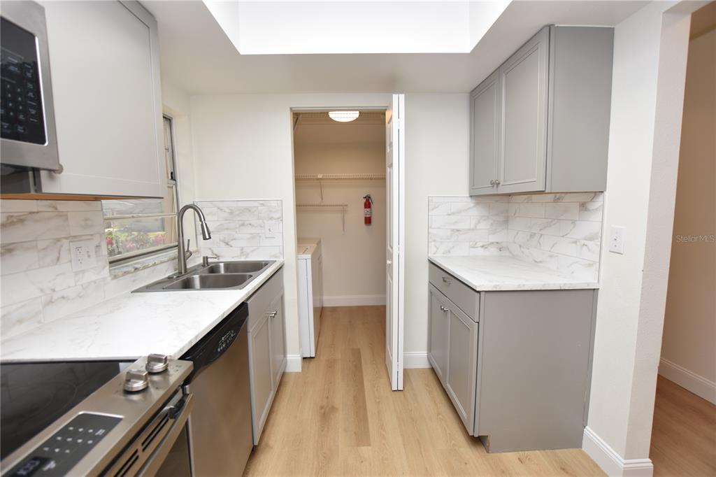 2025 Sylvester Road, Unit S2 Lakeland, FL 33803 - Photo 4 of 36 a kitchen with a sink stove and cabinets