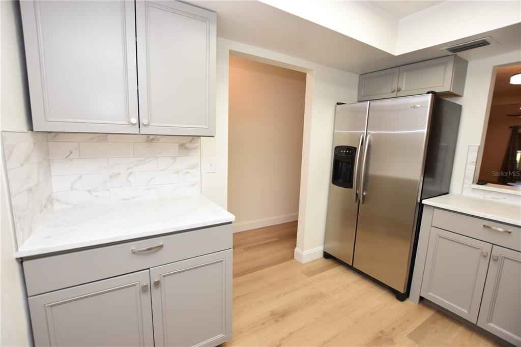 2025 Sylvester Road, Unit S2 Lakeland, FL 33803 - Photo 5 of 36 a kitchen with metallic refrigerator freezer and a dishwasher