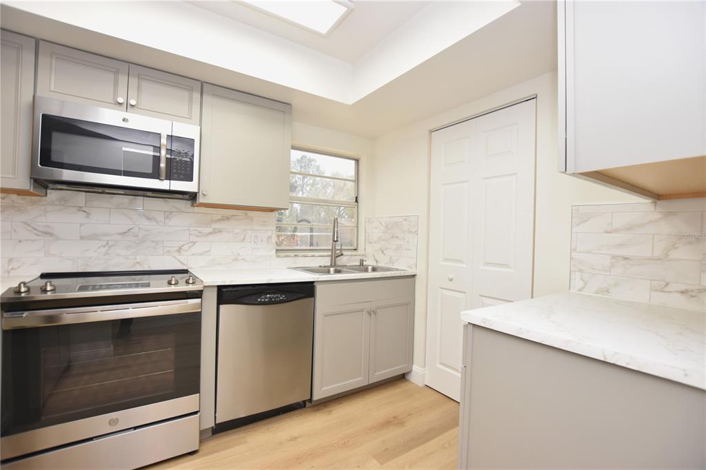 2025 Sylvester Road, Unit S2 Lakeland, FL 33803 - Photo 6 of 36 a kitchen with stainless steel appliances a stove microwave and sink