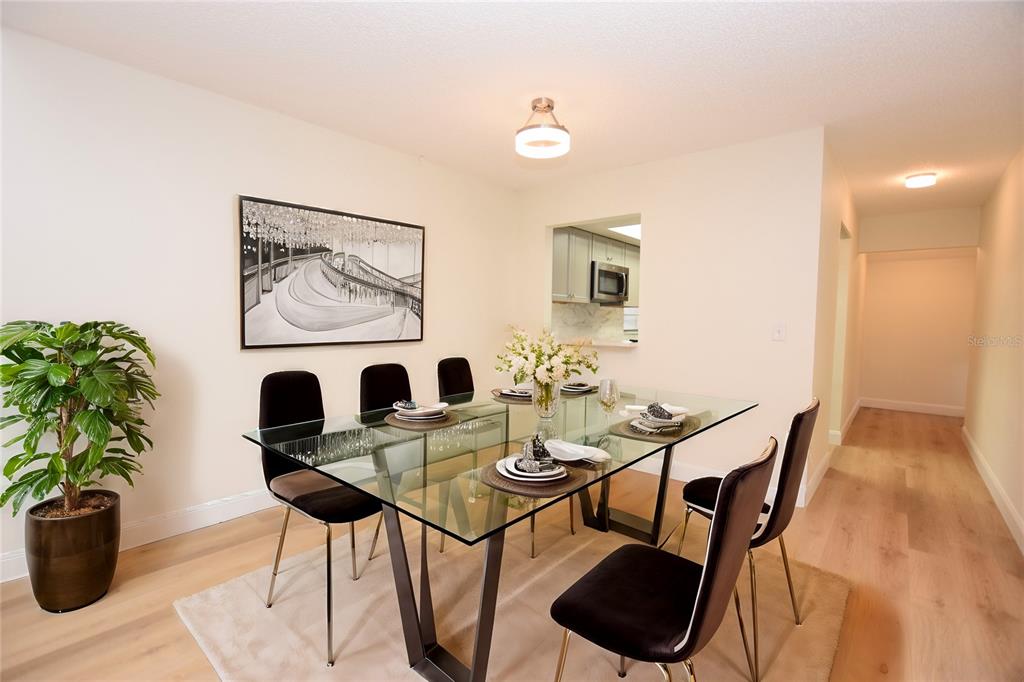 2025 Sylvester Road, Unit S2 Lakeland, FL 33803 - Photo 7 of 36 a view of a dining room with furniture and wooden floor